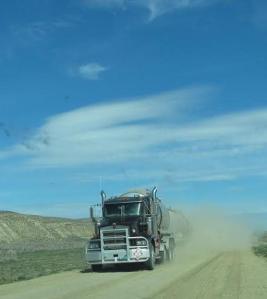 An oil truck envelopes us in dust. Click to enlarge.